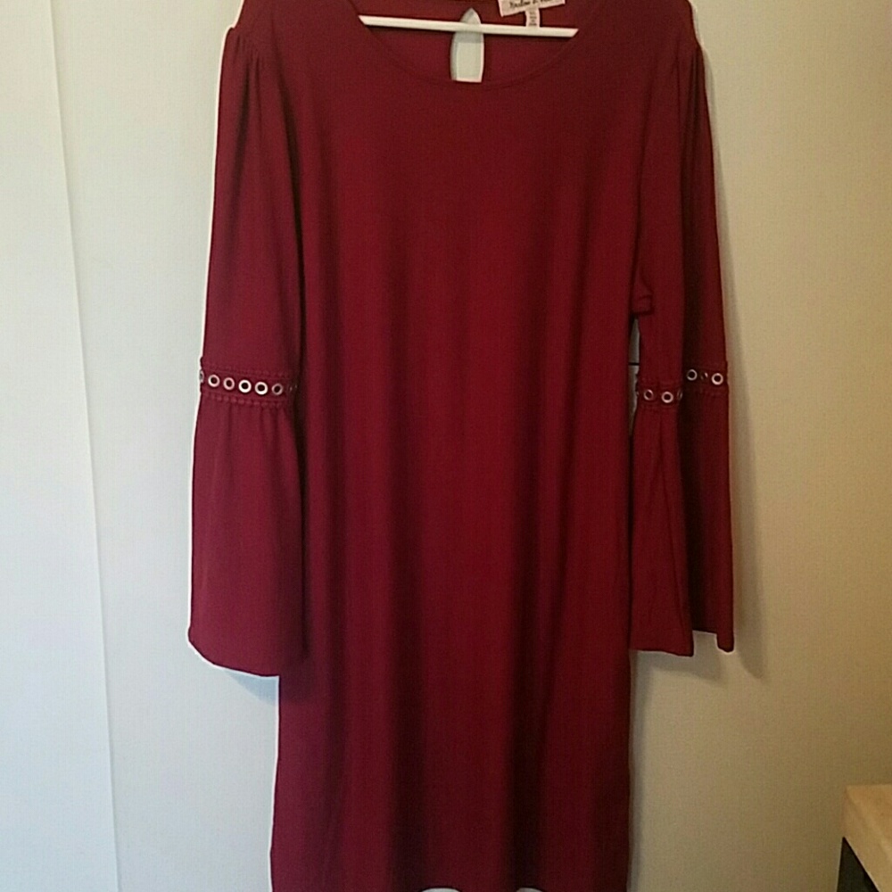 Cute dress. Sleeves flare out under rivets.